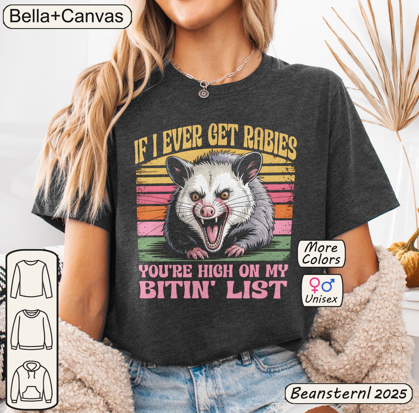 Person wearing a dark gray t-shirt with an opossum graphic and text, with 'Bella+Canvas' branding.