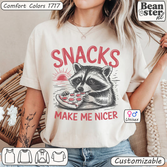Funny raccoon graphic t-shirt with βSnacks Make Me Nicerβ slogan