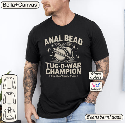 Man wearing a black t-shirt with 'Anal Bead Tug-O-War Champion' design, Bella+Canvas branding visible.
