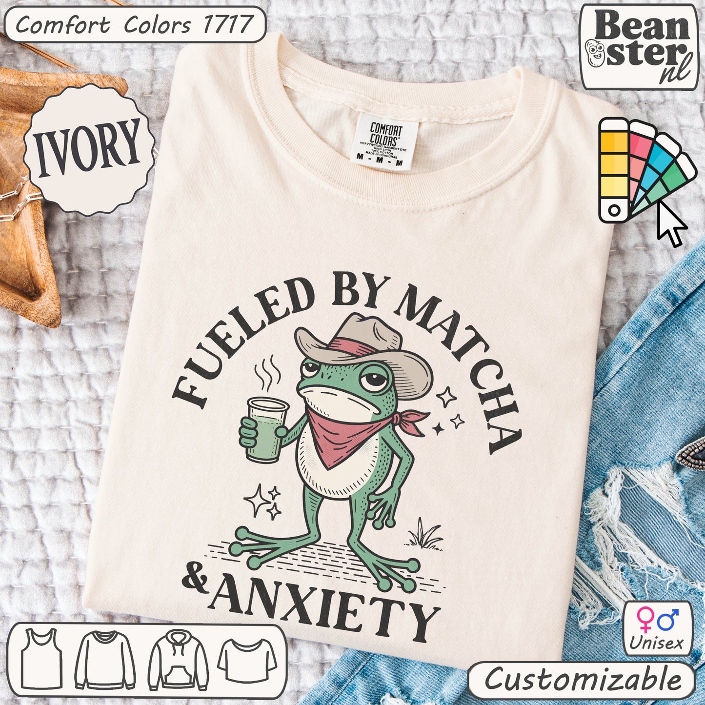 Beige t-shirt with a frog graphic and text 'Fueled by Matcha & Anxiety' on a textured surface.