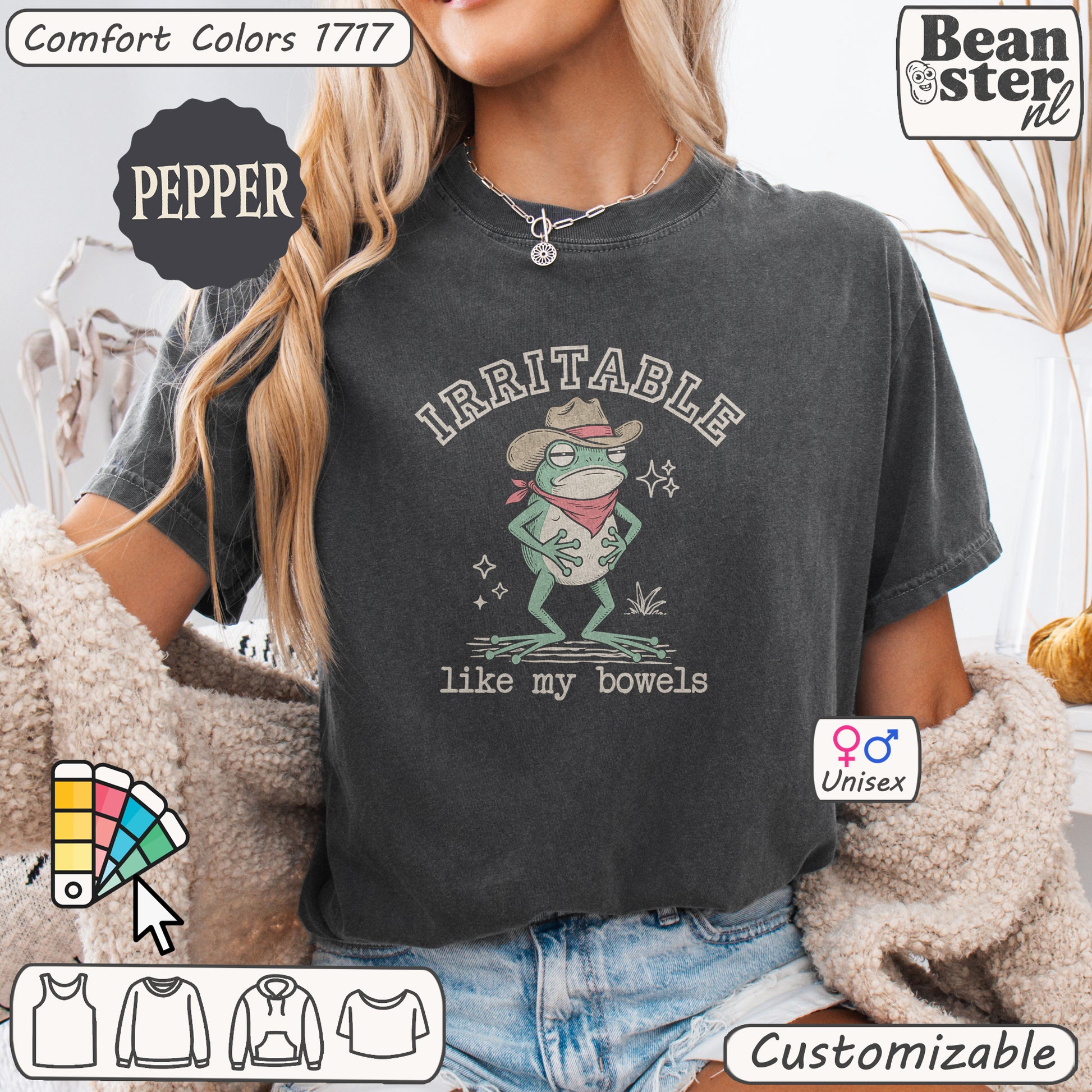 Person wearing a dark gray t-shirt with a graphic design and text, sitting on a textured surface.