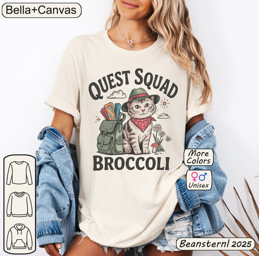 Person wearing a t-shirt with a cat graphic and text 'Quest Squad Broccoli' from Bella+Canvas.