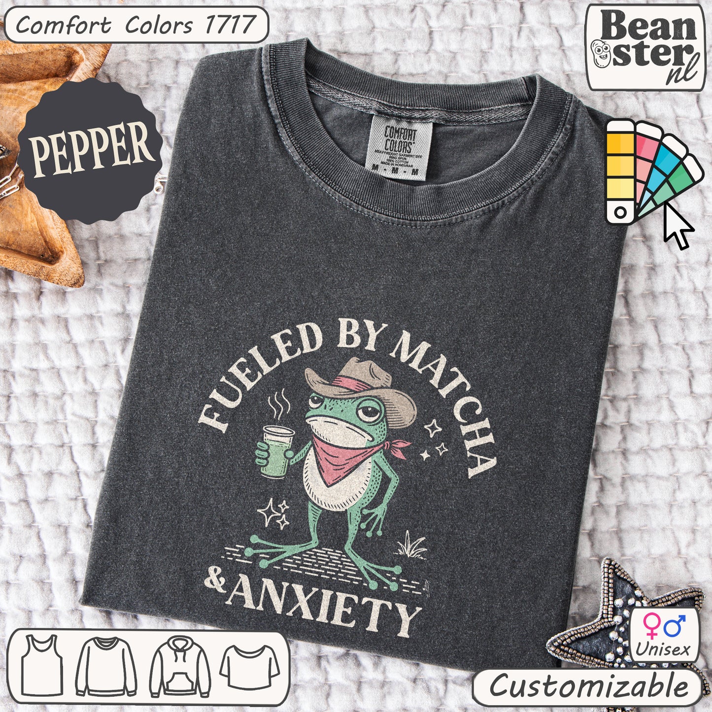 Dark gray t-shirt with a frog graphic and text 'Fueled by Matcha & Anxiety' on a textured surface.