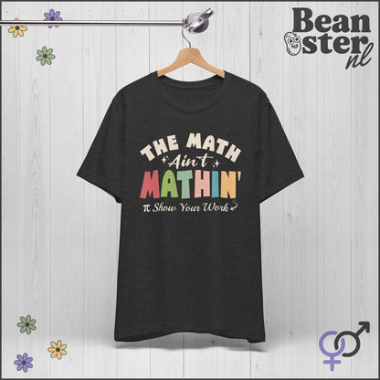 Black t-shirt with colorful text on a hanger against a light wooden background