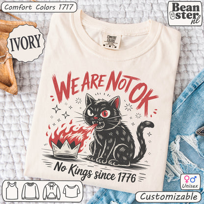 White t-shirt with a black cat graphic and text on a textured surface