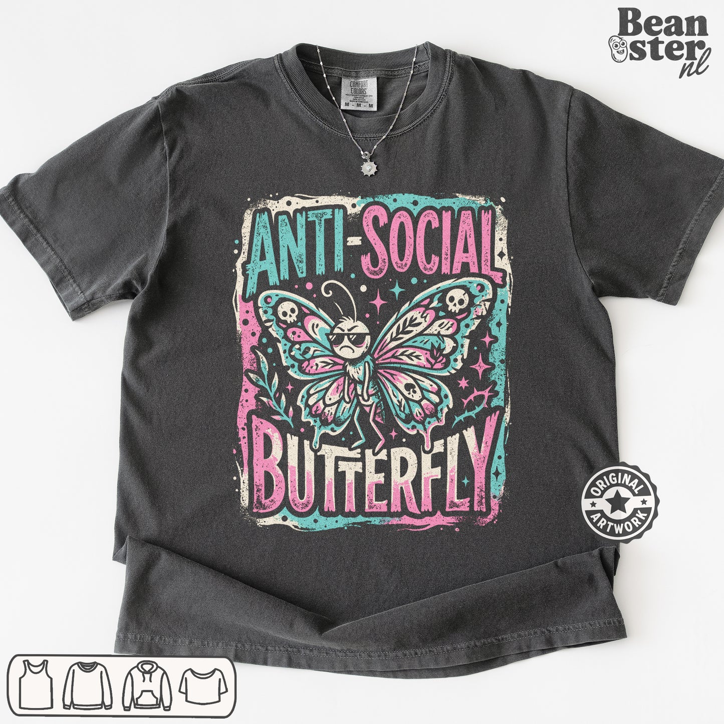 A dark gray graphic t-shirt featuring a distressed print of a butterfly with sunglasses and the text 'ANTI-SOCIAL BUTTERFLY' in pink and teal. The t-shirt is laid flat on a white background with a Beanster.