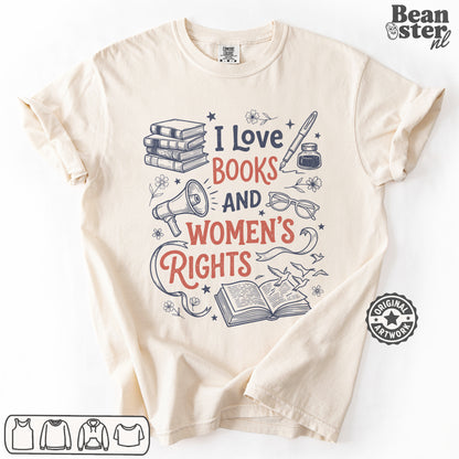 A cream-colored short-sleeve t-shirt with a graphic print that reads 'I Love BOOKS AND WOMEN'S RIGHTS' in navy and coral red lettering, surrounded by illustrations of books, a megaphone, glasses, and an open book.
