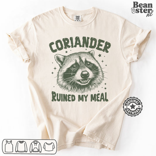Beige t-shirt with raccoon graphic and text 'Coriander Ruined My Meal' on a white background
