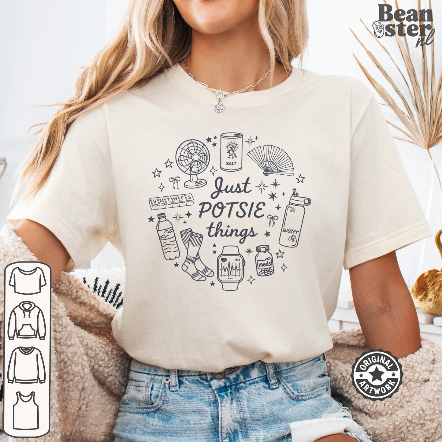 A woman wearing a cream-colored graphic t-shirt with a black line art design that reads 'Just POTSIE things' surrounded by small doodles. The image has a 'Beanster.
