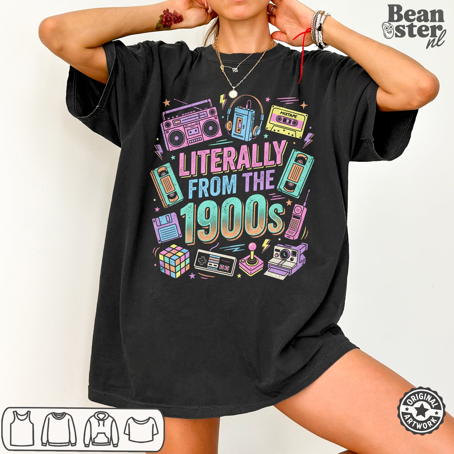 A woman wearing an oversized black graphic T-shirt with retro 1990s-themed illustrations and the text 'LITERALLY FROM THE 1900s'. The image includes a 'Beanster.