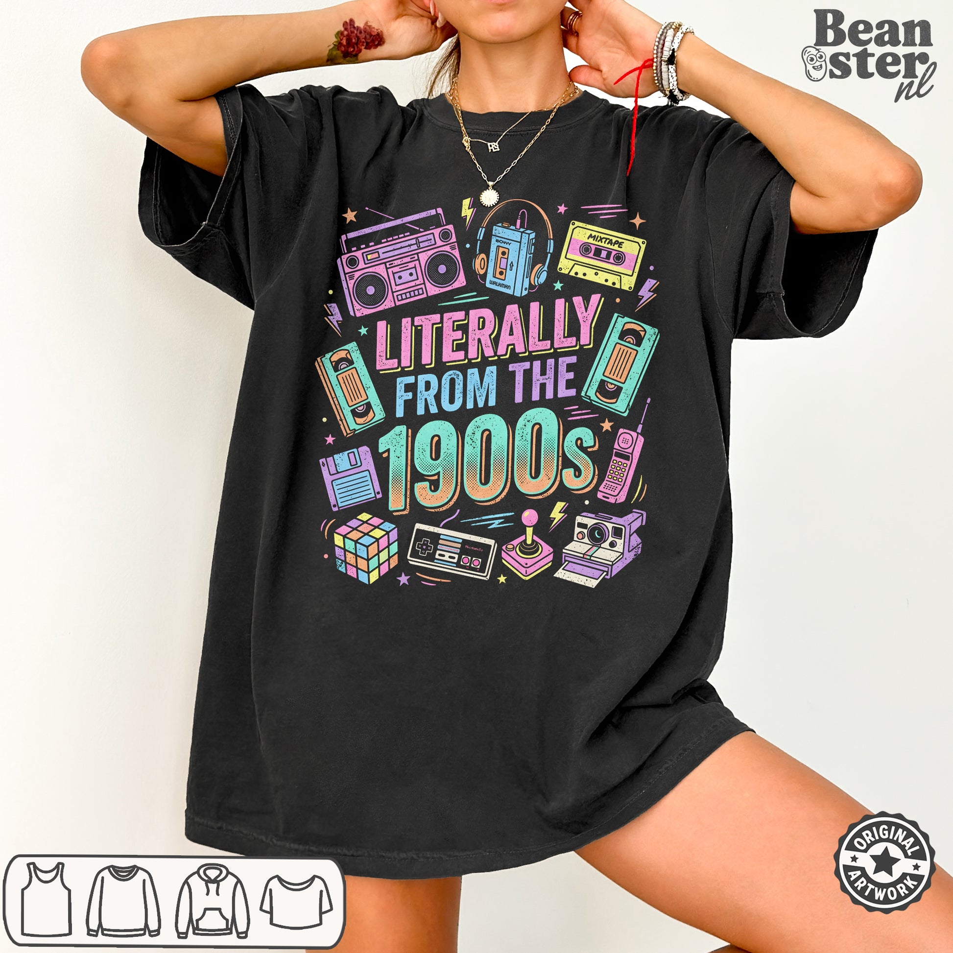 A woman wearing an oversized black graphic T-shirt with retro 1990s-themed illustrations and the text 'LITERALLY FROM THE 1900s'. The image includes a 'Beanster.