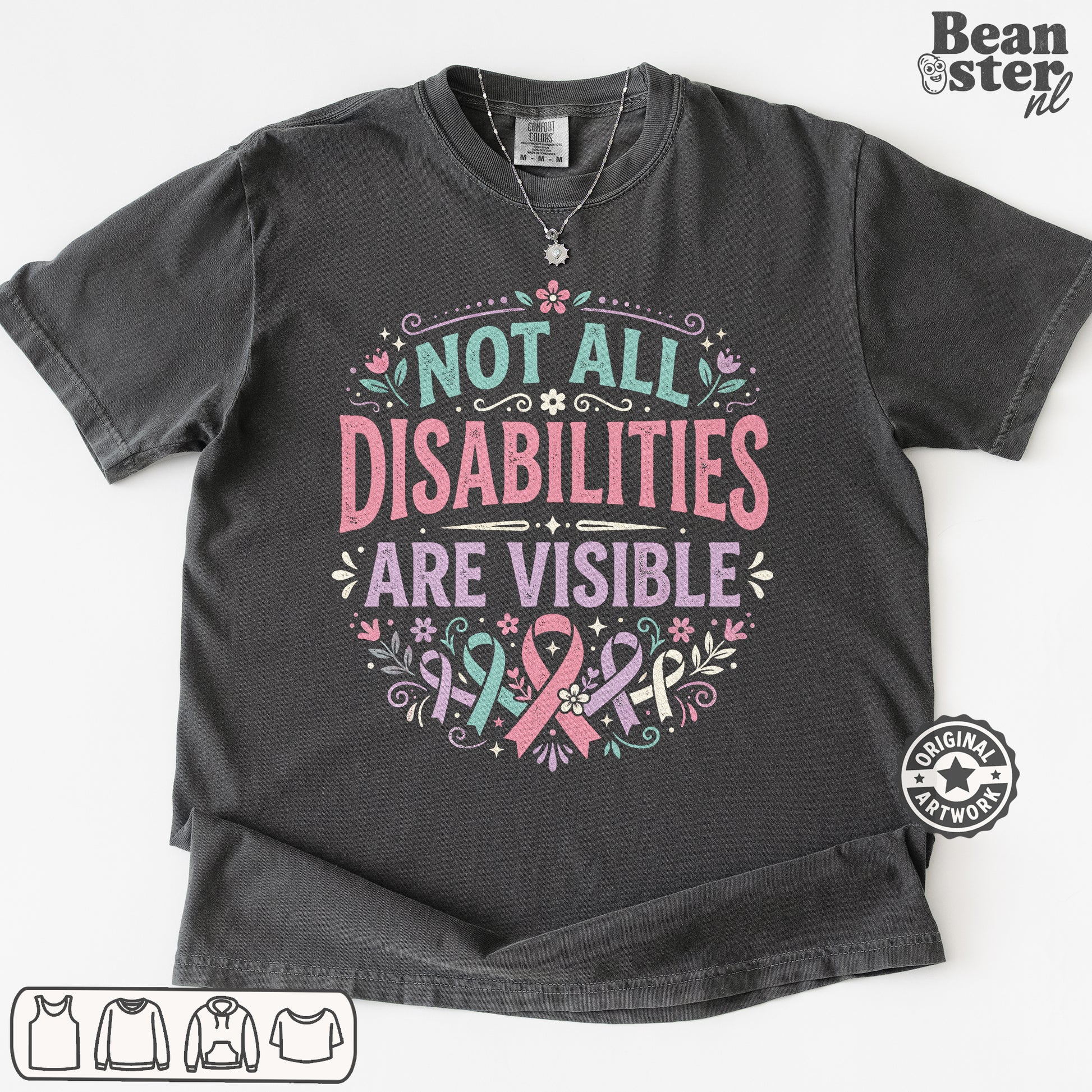 A dark charcoal gray graphic t-shirt laid flat on a white background. The shirt features a printed design with the text 'NOT ALL DISABILITIES ARE VISIBLE' in pink and teal lettering, decorated with pink and teal awareness ribbons, flowers, and leaves.