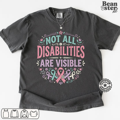 A dark charcoal gray graphic t-shirt laid flat on a white background. The shirt features a printed design with the text 'NOT ALL DISABILITIES ARE VISIBLE' in pink and teal lettering, decorated with pink and teal awareness ribbons, flowers, and leaves.