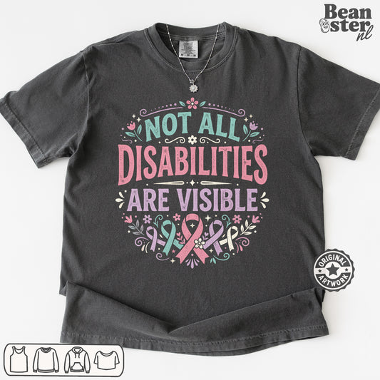 A dark charcoal gray graphic t-shirt laid flat on a white background. The shirt features a printed design with the text 'NOT ALL DISABILITIES ARE VISIBLE' in pink and teal lettering, decorated with pink and teal awareness ribbons, flowers, and leaves.