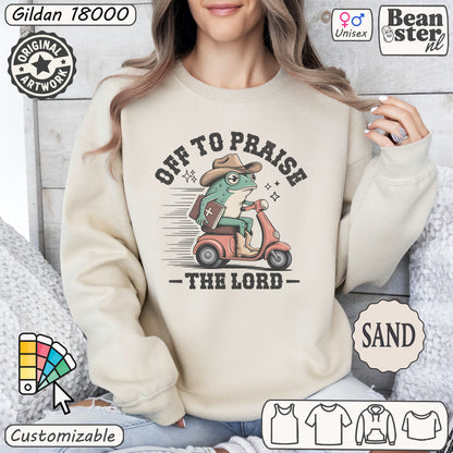 Off To Praise The Lord sweater with silly frog on scooter graphic