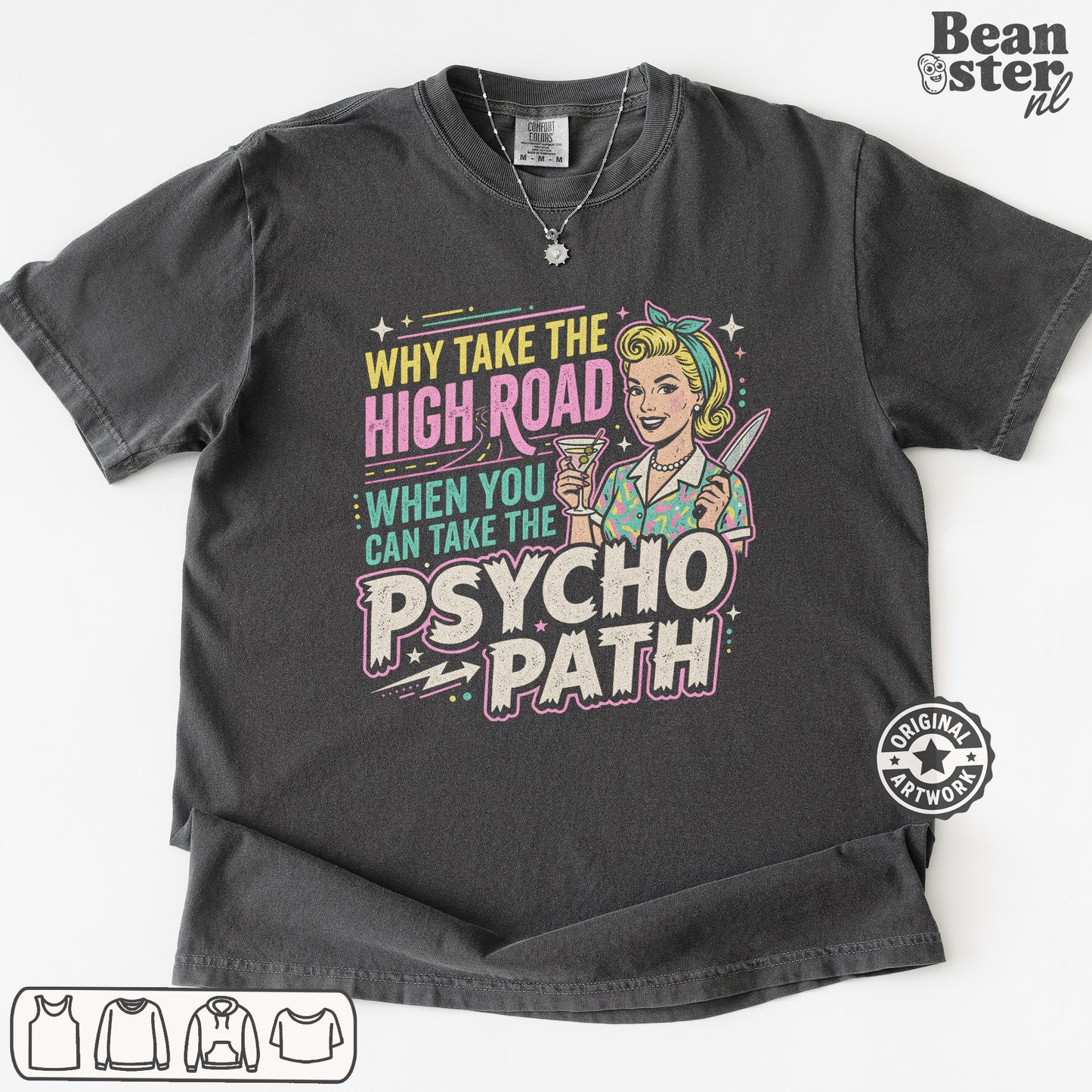 A dark charcoal gray graphic t-shirt laid flat on a white background. The shirt features a retro-style pin-up illustration of a woman with blonde hair and a headband, holding a drink, next to the text 'WHY TAKE THE HIGH ROAD WHEN YOU CAN TAKE THE PSYCHO PATH' in pink, yellow, and teal lettering.