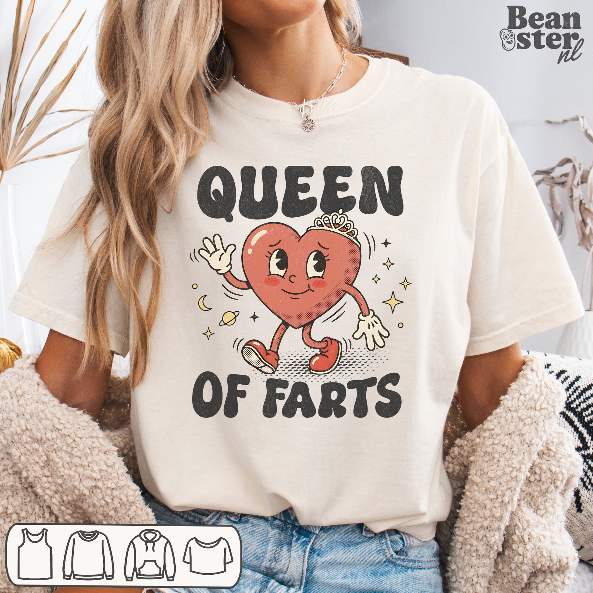 Person wearing a white t-shirt with a heart graphic and 'Queen of Farts' text, sitting on a couch.