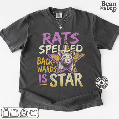 A dark gray graphic t-shirt featuring a distressed print with the text 'RATS SPELED BACKWARDS IS STAR' and a cartoon rat inside a star. The t-shirt is laid flat on a white background with a 'Beanster.