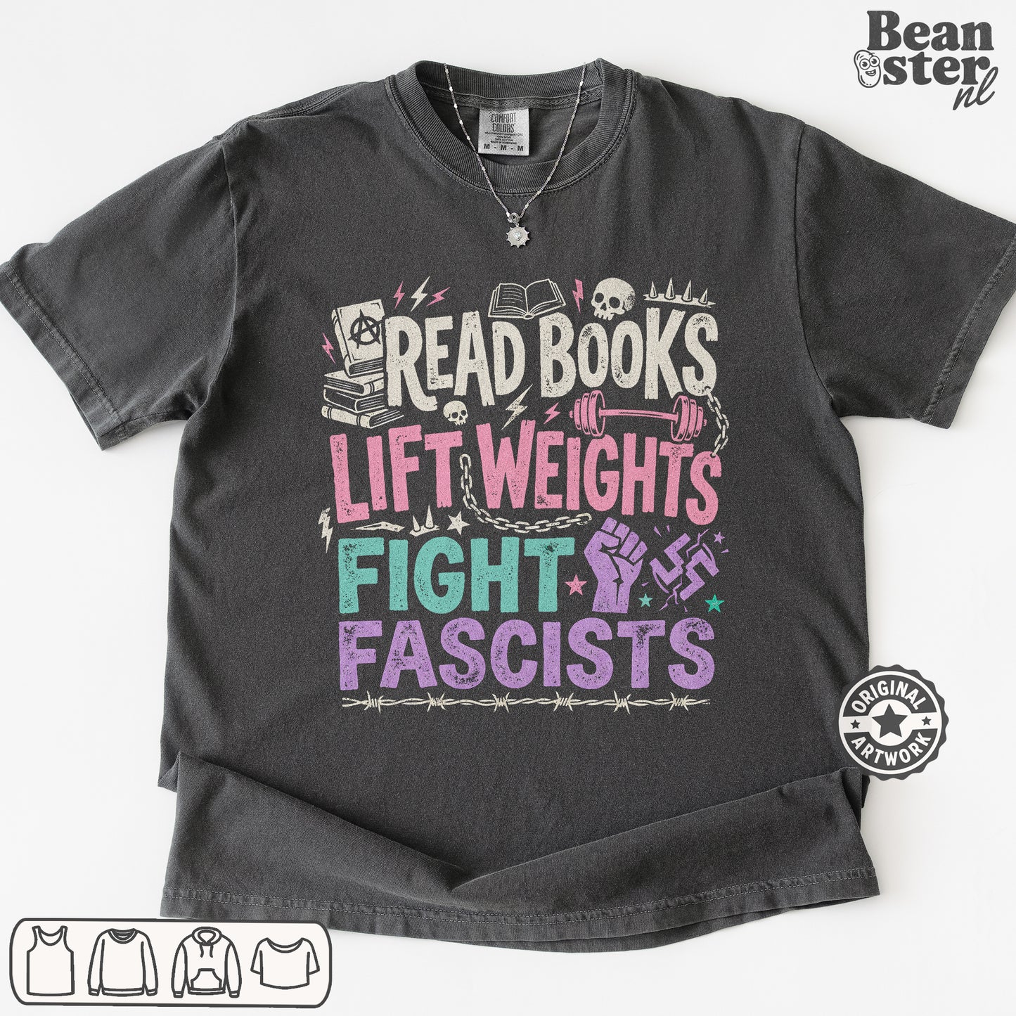 A dark gray graphic t-shirt laid flat on a white background. The shirt features a colorful distressed print with the text 'READ BOOKS LIFT WEIGHS FIGHT FASCISTS' accompanied by illustrations of books, skulls, a dumbbell, a raised fist, and a swastika symbol.