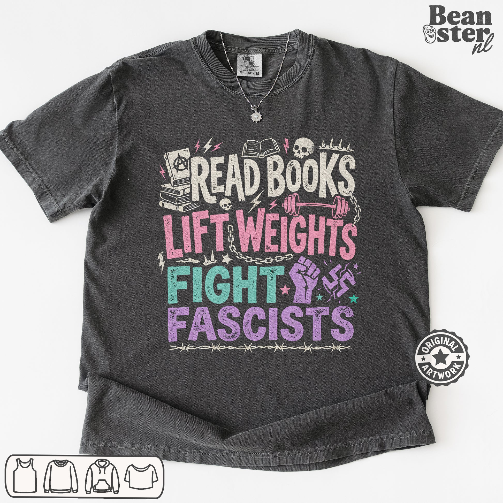 A dark gray graphic t-shirt laid flat on a white background. The shirt features a colorful distressed print with the text 'READ BOOKS LIFT WEIGHS FIGHT FASCISTS' accompanied by illustrations of books, skulls, a dumbbell, a raised fist, and a swastika symbol.