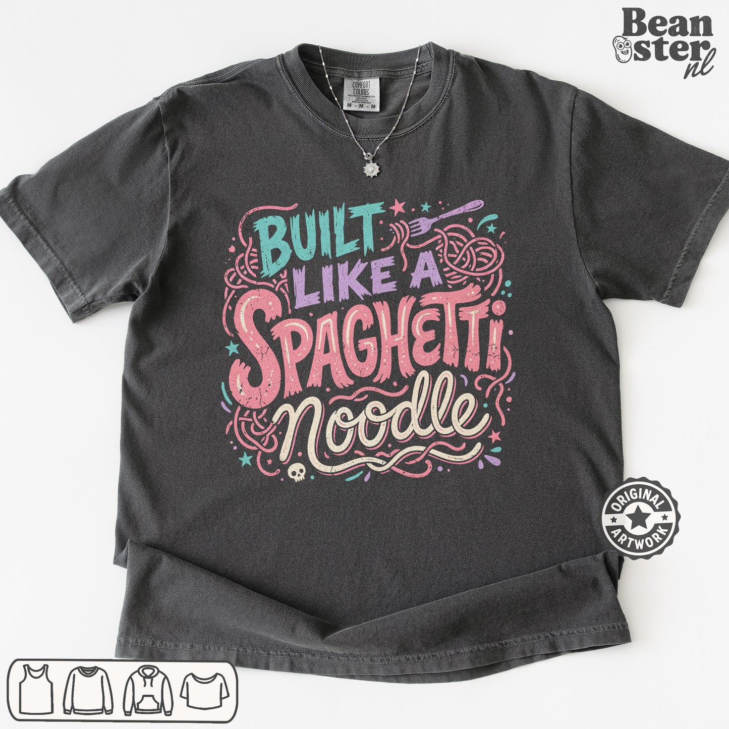 A dark gray graphic t-shirt featuring the text 'Built Like a Spaghetti Noodle' in stylized pink, purple, and teal lettering with pasta illustrations. The t-shirt is displayed flat against a white background with a 'Beanster.