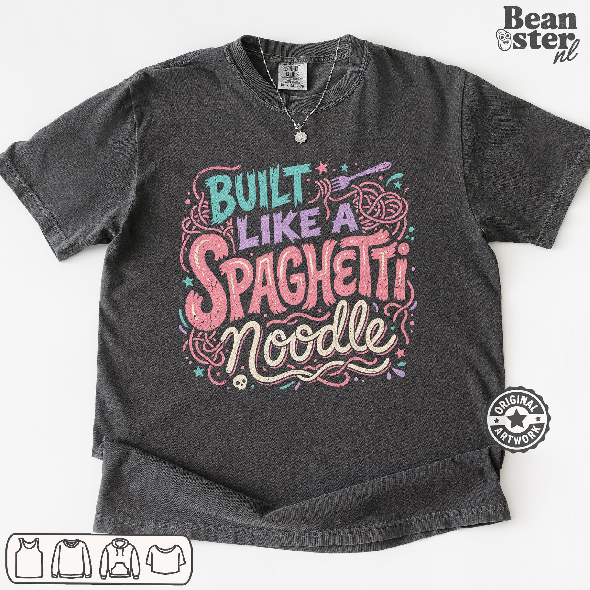 A dark gray graphic t-shirt featuring the text 'Built Like a Spaghetti Noodle' in stylized pink, purple, and teal lettering with pasta illustrations. The t-shirt is displayed flat against a white background with a 'Beanster.