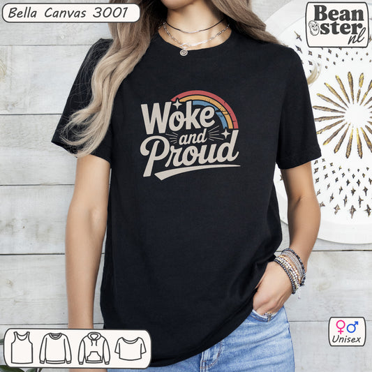 Person wearing a black t-shirt with 'Woke and Proud' text and rainbow design, standing against a light wooden panel background.